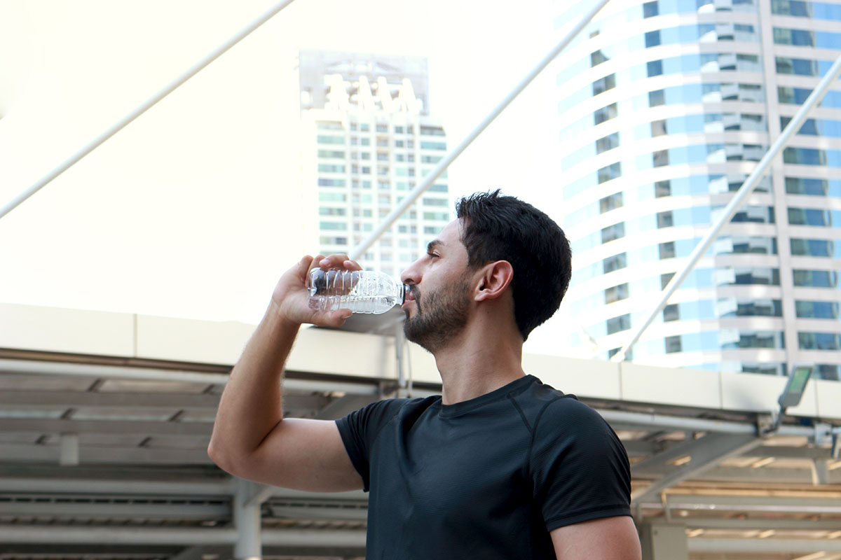 Man drinking water after exercise run outdoor