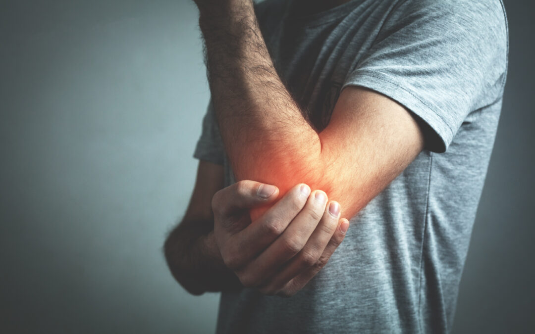 Caucasian man with elbow pain. Pain relief concept